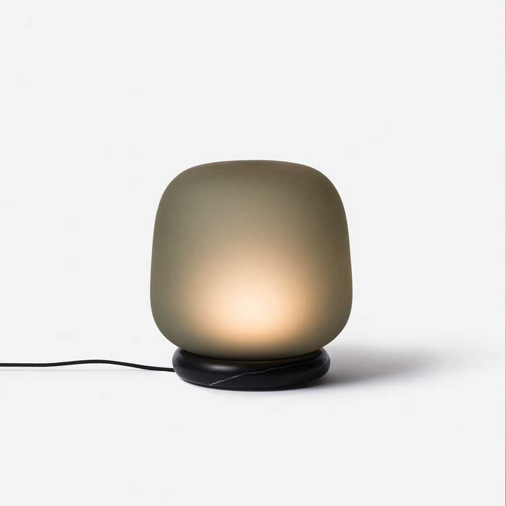 The shade is crafted from hand-blown frosted glass and the base is made from solid marble. A dimmable LED light source means the lamp creates a subtle, sophisticated glow.