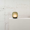 The shade is crafted from hand-blown frosted glass and the base is made from solid marble. A dimmable LED light source means the lamp creates a subtle, sophisticated glow.