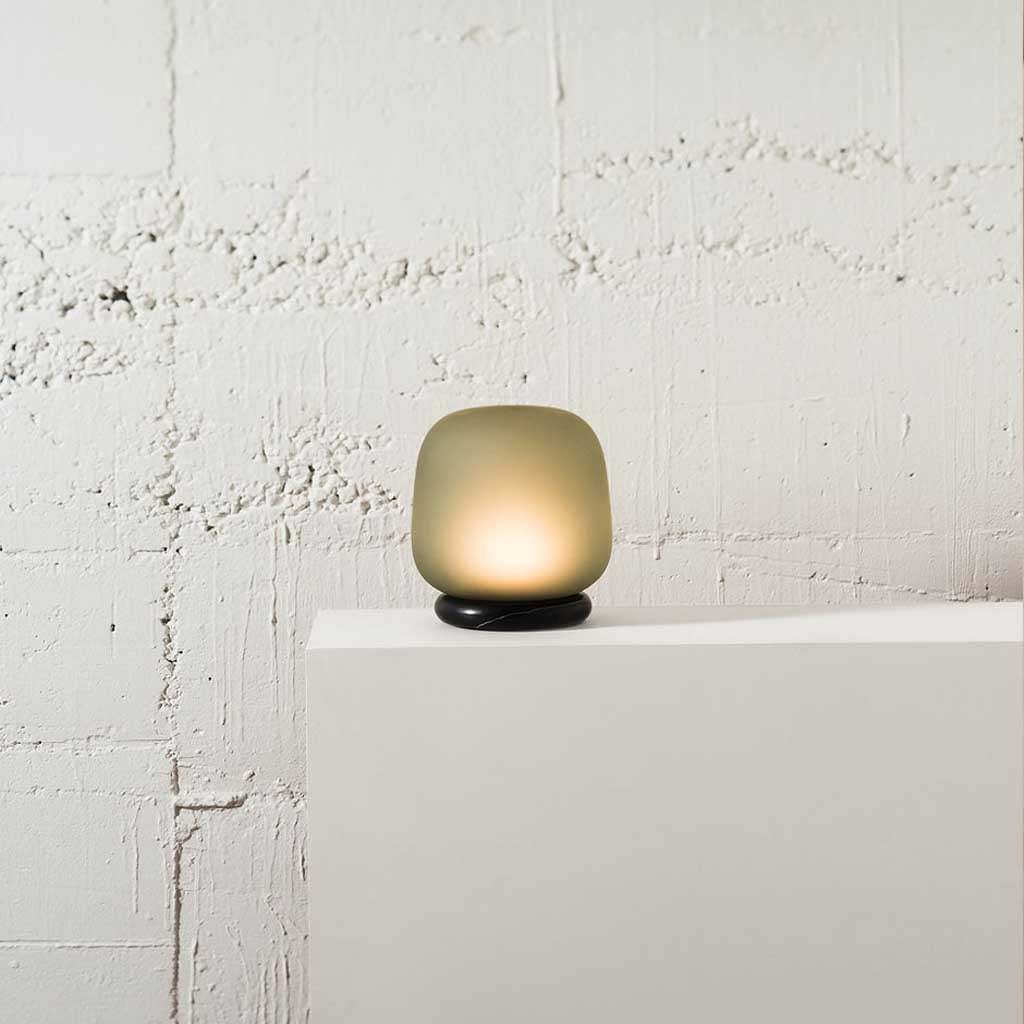 The shade is crafted from hand-blown frosted glass and the base is made from solid marble. A dimmable LED light source means the lamp creates a subtle, sophisticated glow.