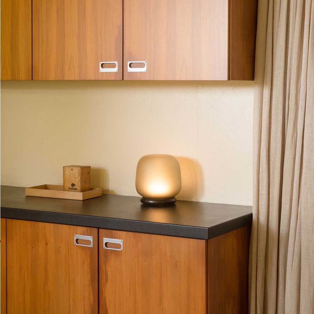 The shade is crafted from hand-blown frosted glass and the base is made from solid marble. A dimmable LED light source means the lamp creates a subtle, sophisticated glow.