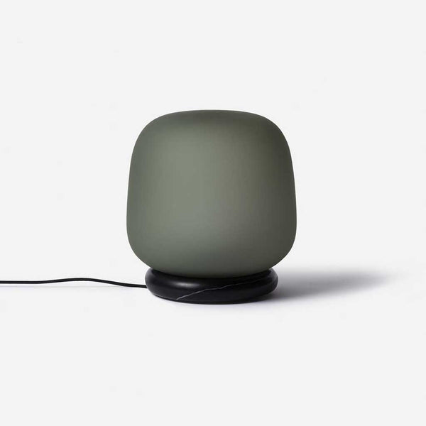 The shade is crafted from hand-blown frosted glass and the base is made from solid marble. A dimmable LED light source means the lamp creates a subtle, sophisticated glow.