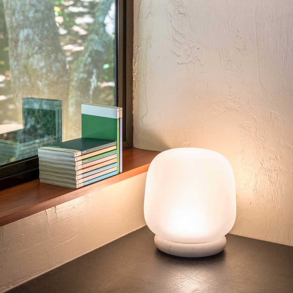The shade is crafted from hand-blown frosted glass and the base is made from solid marble. A dimmable LED light source means the lamp creates a subtle, sophisticated glow.