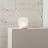 The shade is crafted from hand-blown frosted glass and the base is made from solid marble. A dimmable LED light source means the lamp creates a subtle, sophisticated glow.