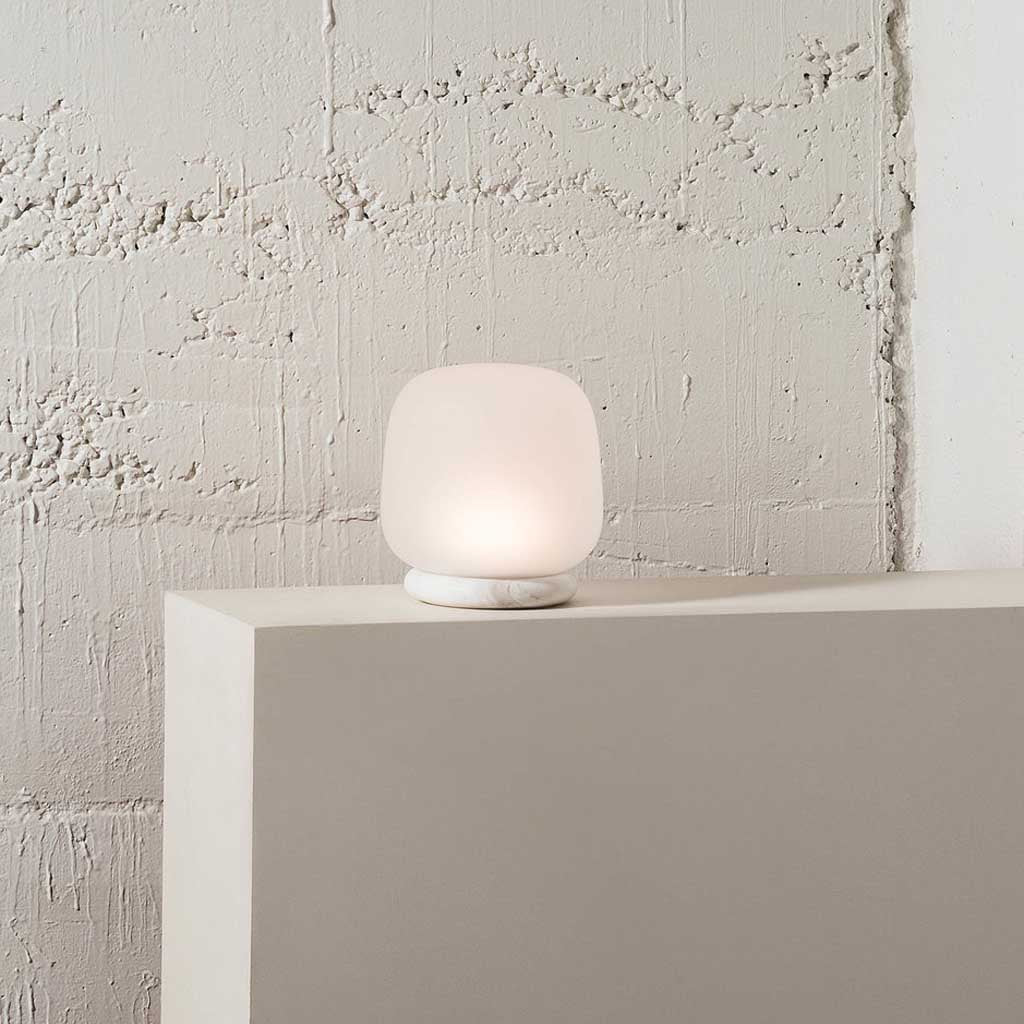 The shade is crafted from hand-blown frosted glass and the base is made from solid marble. A dimmable LED light source means the lamp creates a subtle, sophisticated glow.