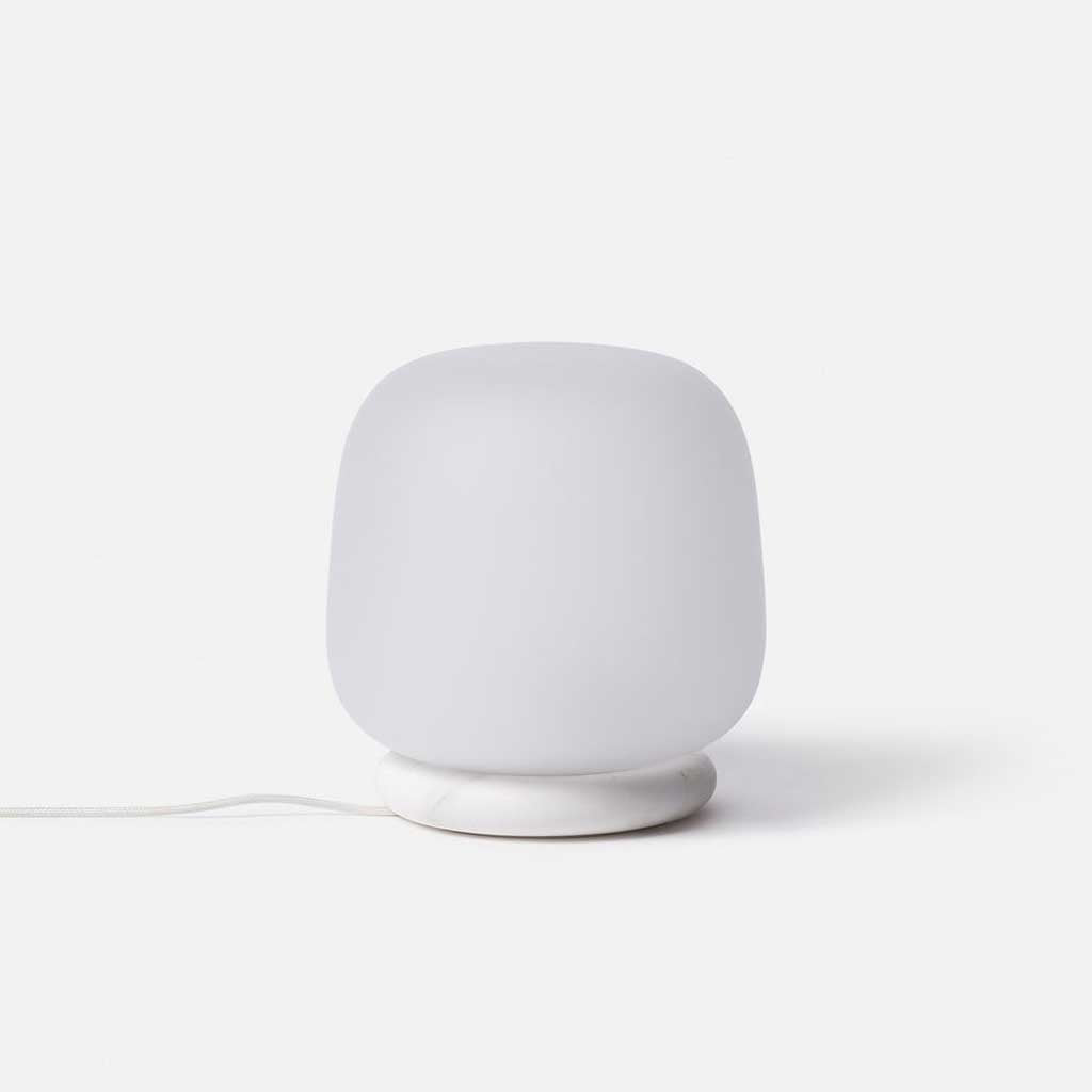 The shade is crafted from hand-blown frosted glass and the base is made from solid marble. A dimmable LED light source means the lamp creates a subtle, sophisticated glow.