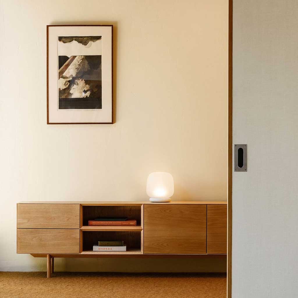The shade is crafted from hand-blown frosted glass and the base is made from solid marble. A dimmable LED light source means the lamp creates a subtle, sophisticated glow.