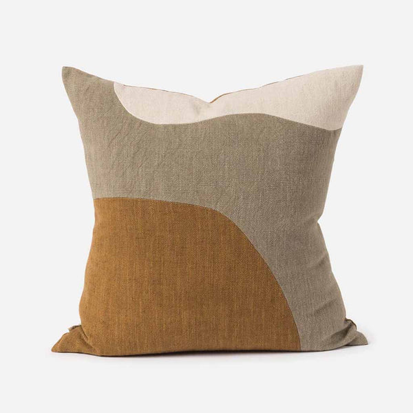 The Bluff Cushion Cover features a constructed patchwork that celebrates the organic forms found in nature. The design reveals an abstract landscape, reminiscent of a New Zealand bluff.