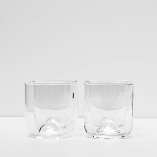 The Capsule Glass Set is made in Kristina Dams' Studio based in Copenhagen, Denmark. The unique "capsule" design leaves an air bubble in the middle of the glass - this serves both as a characteristic design feature and as a glass cork for the Carafe. Handmade, please expect small differences in shape. 