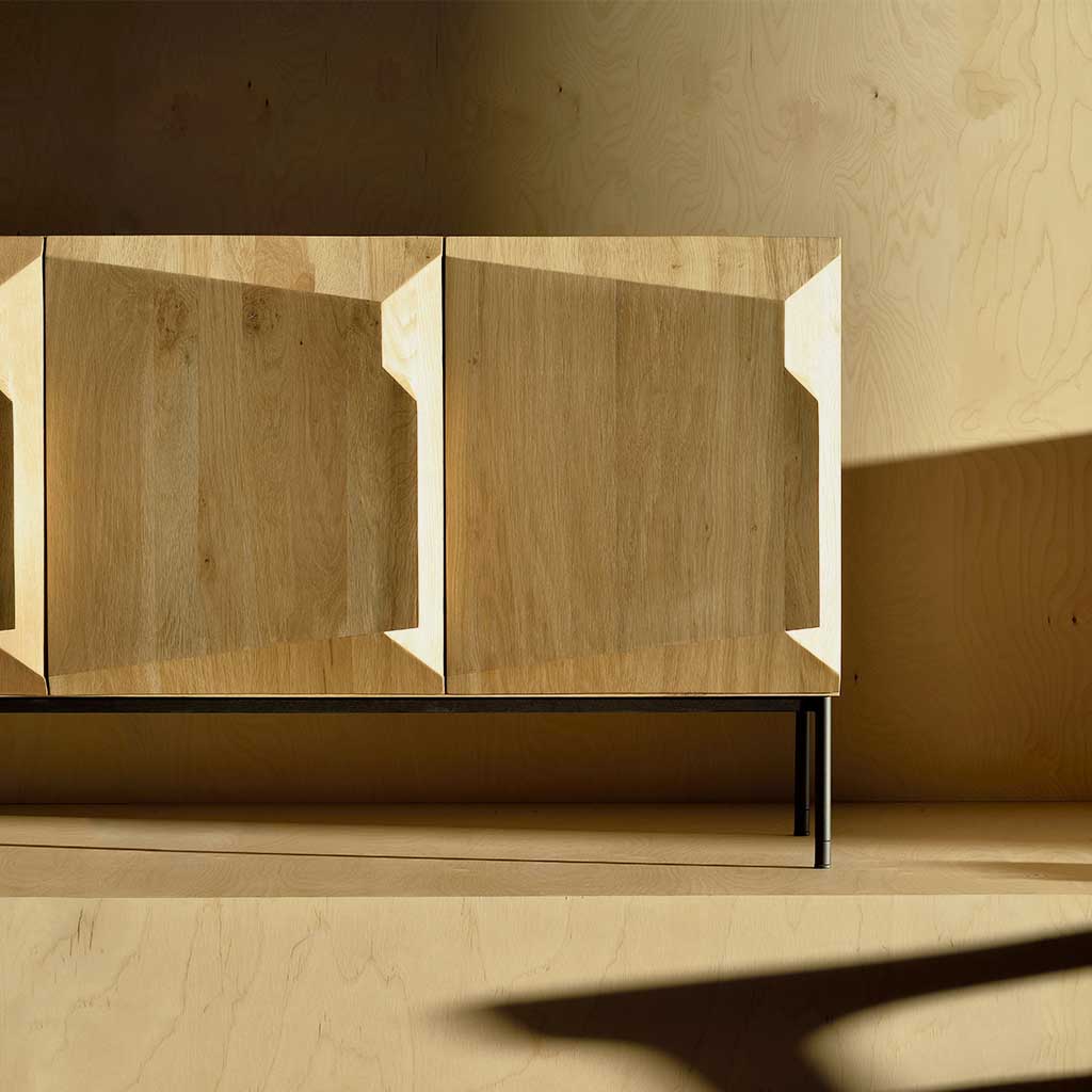 With its sculptural design and soft angles, the Step Sideboard is an interesting and unconventional piece. Visually stunning, this beautiful oak sideboard with contrasting black metal legs, is practical yet unique, featuring three spacious compartments.  A stylish addition to elevate your hallway or living space.