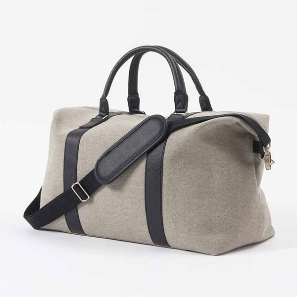 The durable Canvas Weekender Bag is a simple, relaxed design featuring robust handles and a comfortable shoulder strap.
